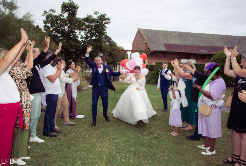 Haie d'honneur des invités lors de l'entrée des mariés dans la salle de réception avec une animation de mariage organisée par LoL Événements.